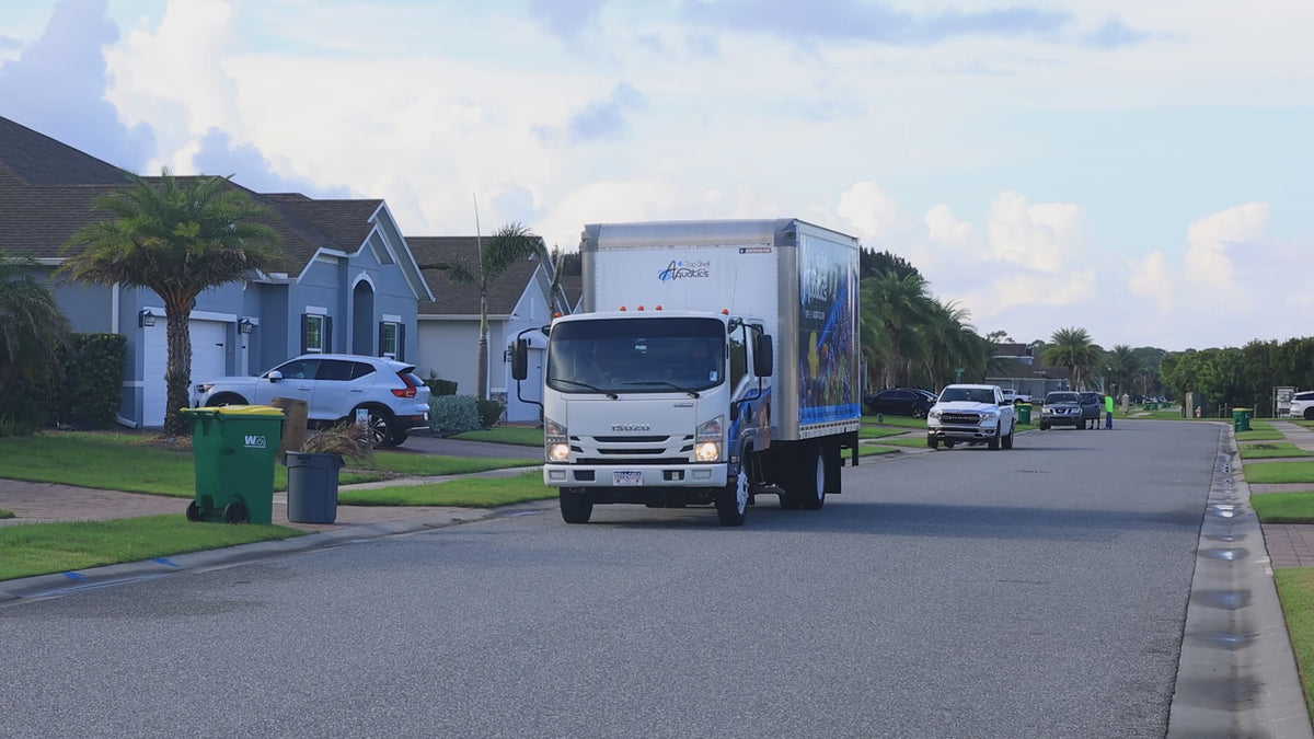 Top Shelf Aquatics installation truck arriving in a Central Florida neighborhood