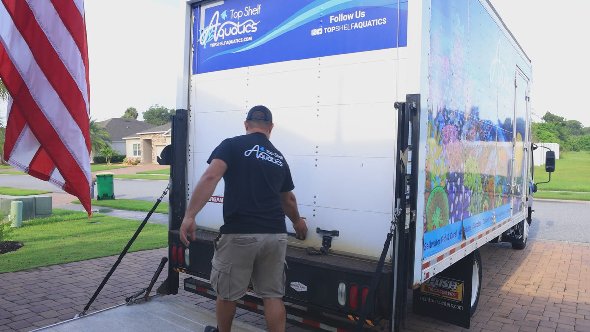 Top Shelf Aquatics installer opening the delivery truck lift gate at a client home