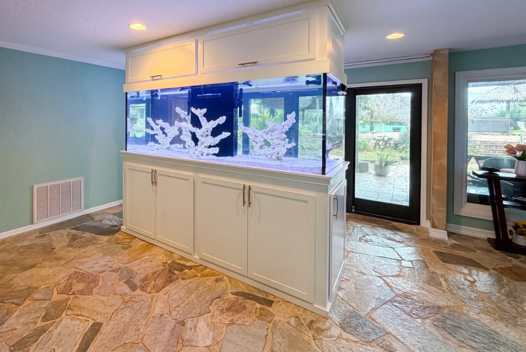 Rear view of a white peninsula aquarium with integrated canopy and cabinetry